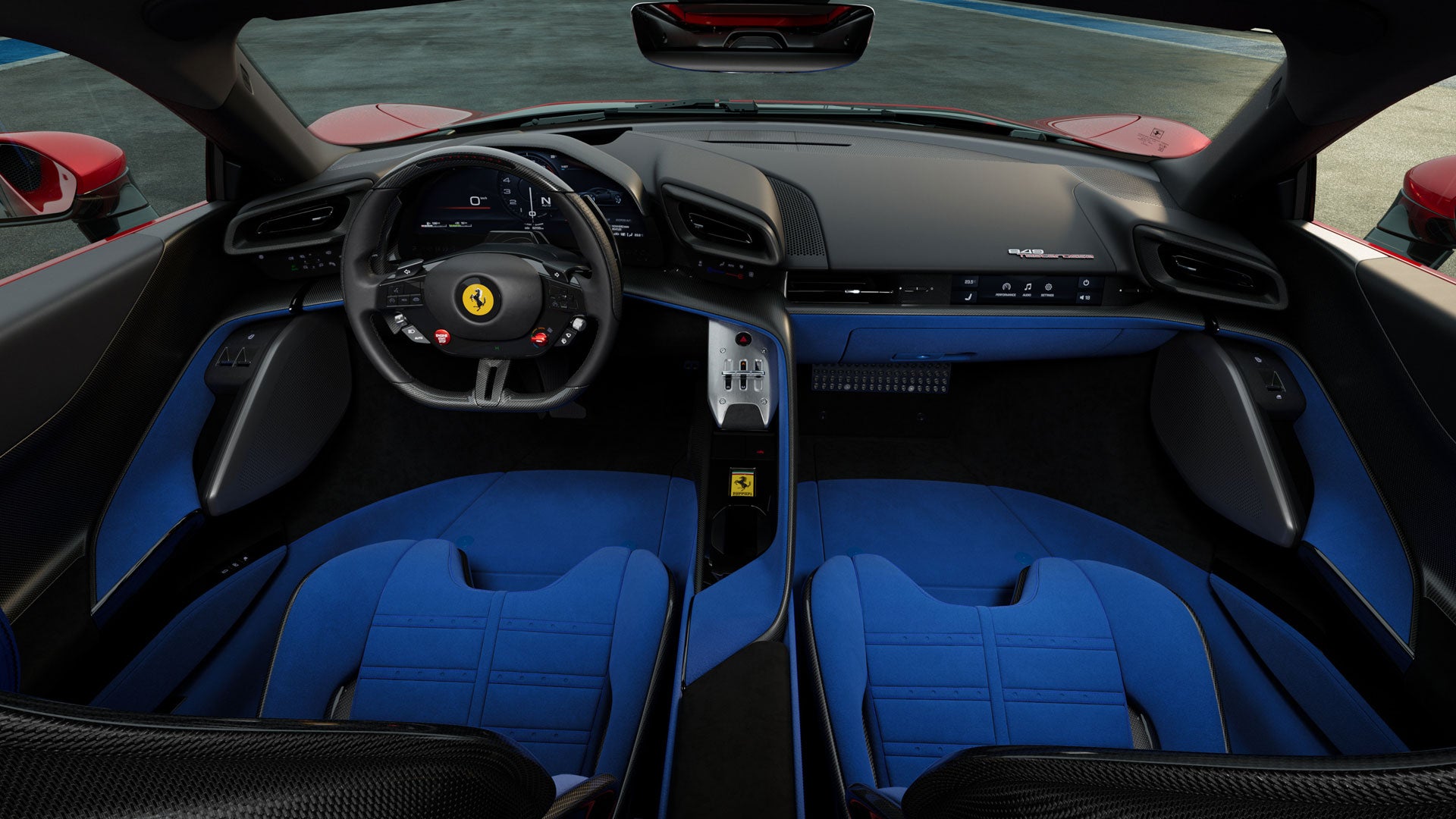 Overhead view of a Ferrari interior with black and blue trim. Two blue racing seats separated by a central console are visible.